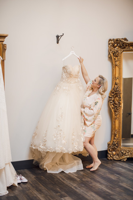 Melissa Birchett's Story pulling dress off of hanger