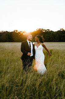 Jasmyn Poe + David Arechiga outside in the grass at Emerson Venue in Dallas Fort Worth Texas after the wedding ceremony before the reception.