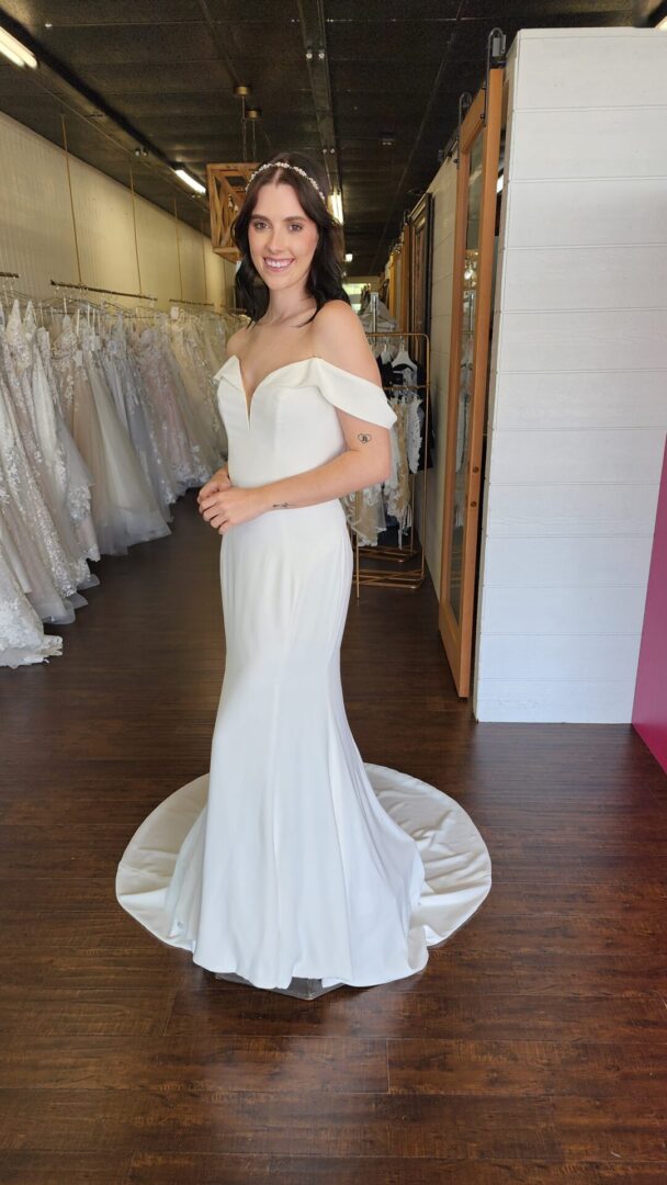 Off the Shoulder Fitted Minimal Wedding Dress with V Neckline and Detailed Lace Illusion Back